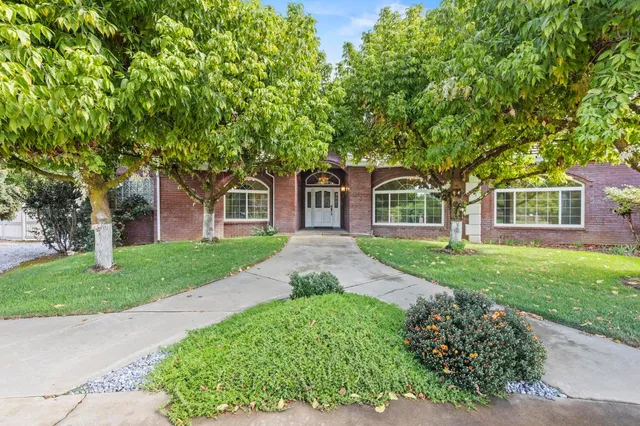 a front view of a house with a yard