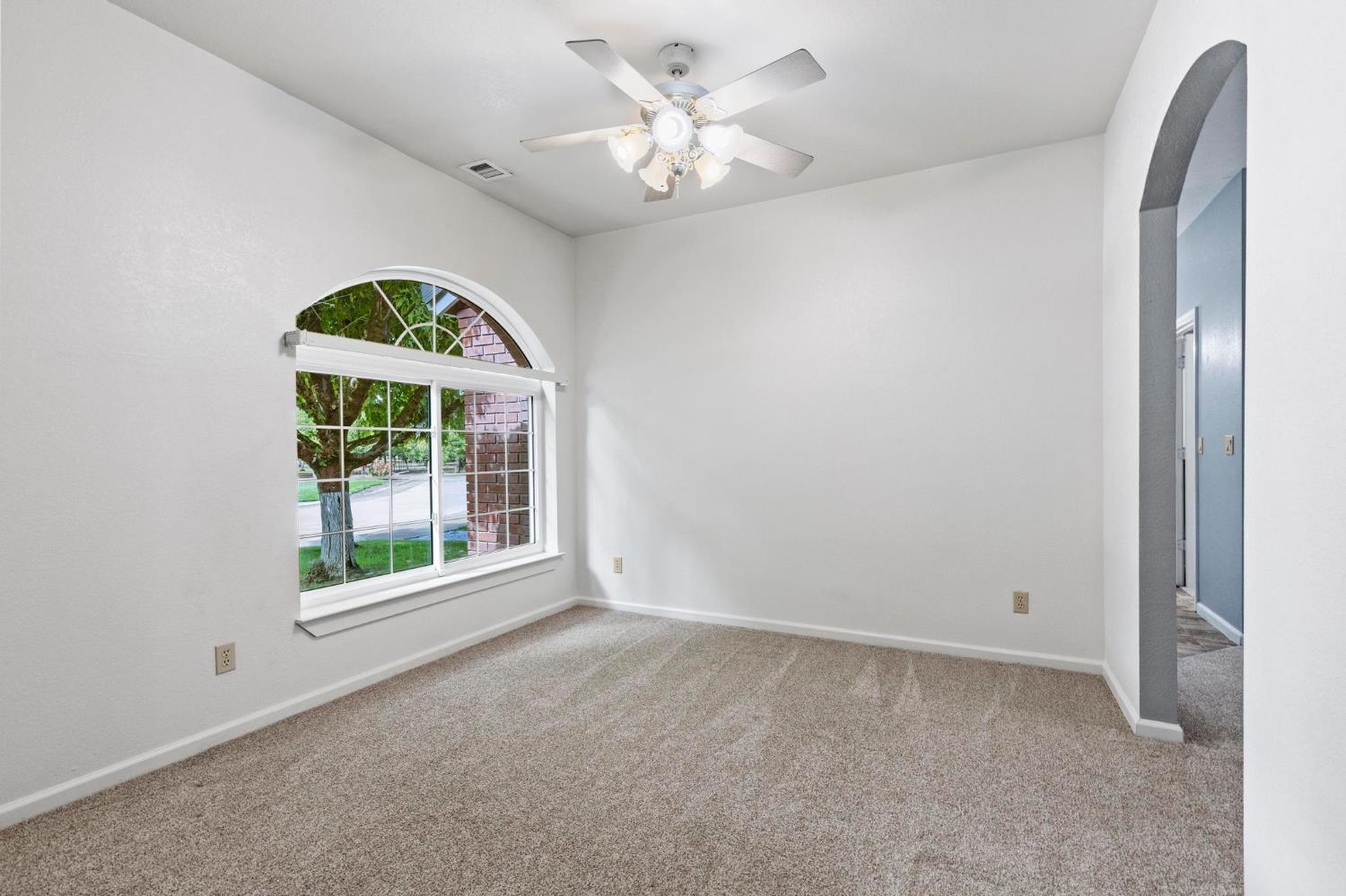 10963 Metteer Road Live Oak, CA 95953 - Photo 15 of 73 an empty room with a window and a fan