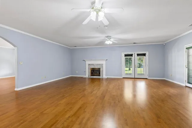a kitchen with stainless steel appliances white cabinets granite counter tops and a window