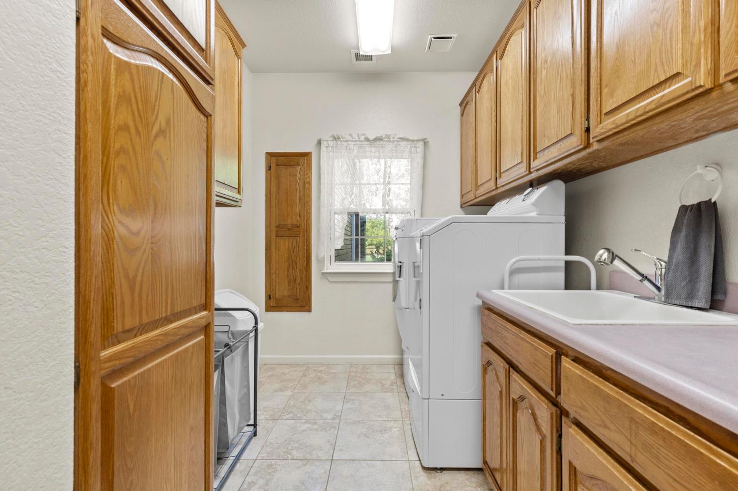 10963 Metteer Road Live Oak, CA 95953 - Photo 40 of 73 a kitchen with a sink a refrigerator and cabinets