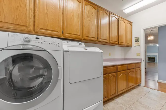 a kitchen with refrigerator and cabinets