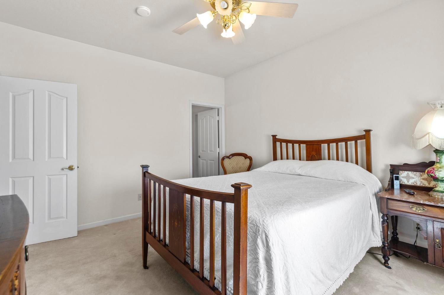 10963 Metteer Road Live Oak, CA 95953 - Photo 44 of 73 a bedroom with a bed and a chandelier