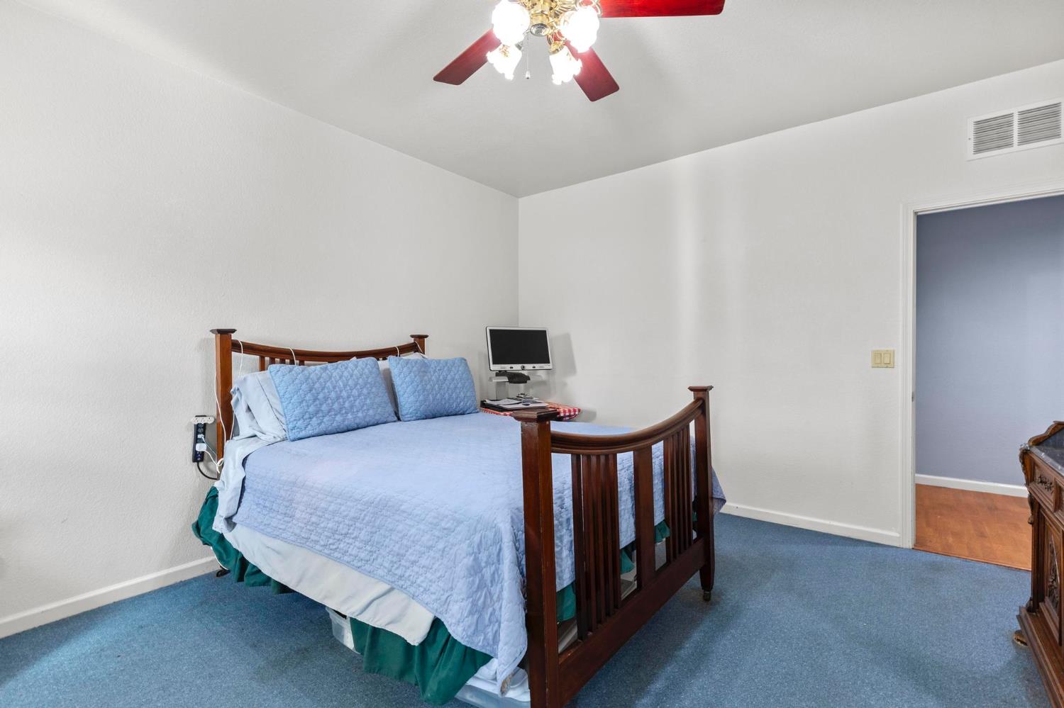 10963 Metteer Road Live Oak, CA 95953 - Photo 48 of 73 a bedroom with a bed and a chandelier