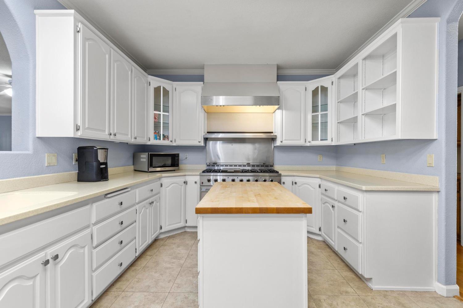 10963 Metteer Road Live Oak, CA 95953 - Photo 53 of 73 a kitchen with stainless steel appliances white cabinets granite counter tops and a window