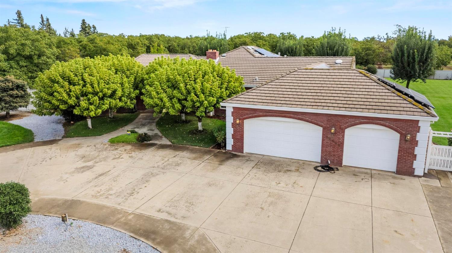 10963 Metteer Road Live Oak, CA 95953 - Photo 7 of 73 a front view of a house with a yard garage and outdoor seating