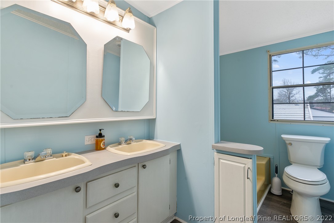 355 Red Hill Road Cameron, NC 28326 - Photo 31 of 48 a bathroom with a toilet sink and mirror