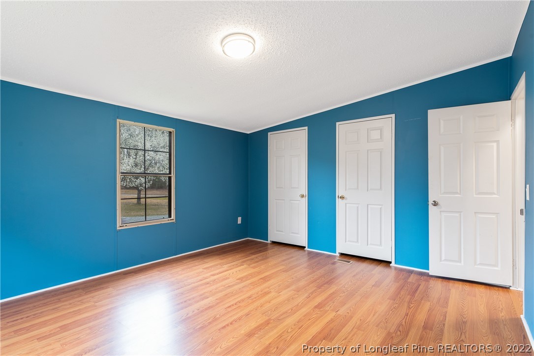 355 Red Hill Road Cameron, NC 28326 - Photo 35 of 48 a view of an empty room with wooden floor and a window