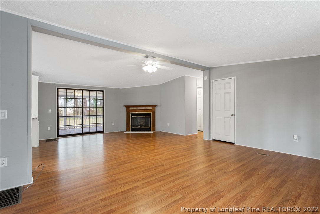 355 Red Hill Road Cameron, NC 28326 - Photo 7 of 48 a view of an empty room with window and wooden floor