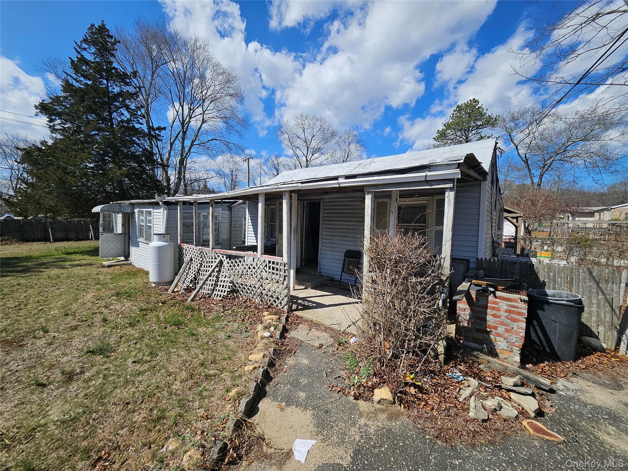 549 Granny Road Medford, NY 11763 - Photo 11 of 37 front view of a house with a large tree