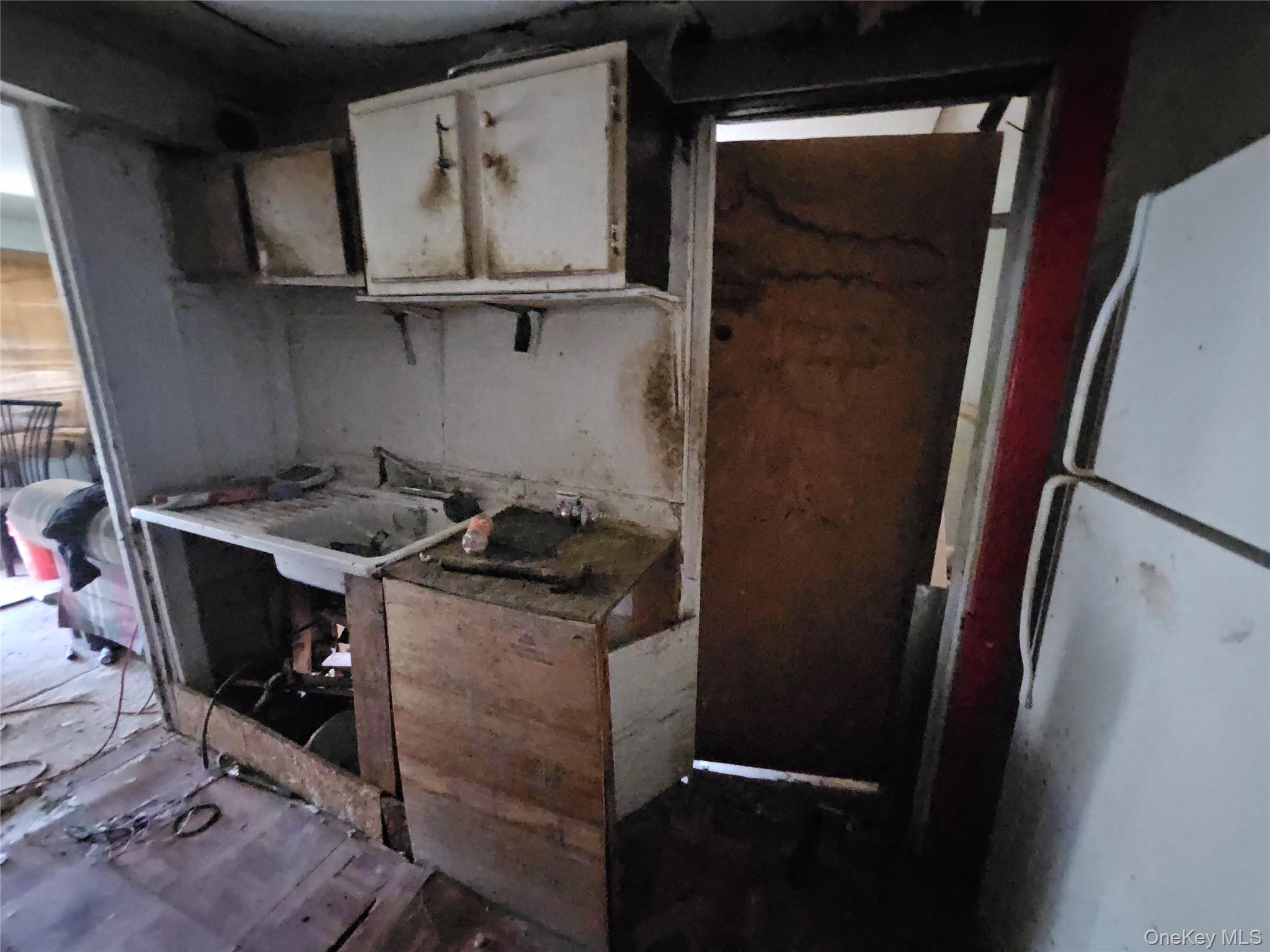 549 Granny Road Medford, NY 11763 - Photo 23 of 37 a kitchen with a refrigerator and a stove