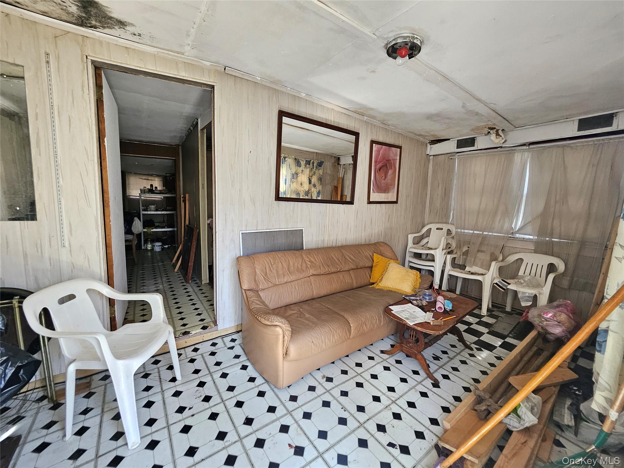549 Granny Road Medford, NY 11763 - Photo 26 of 37 a living room with furniture a rug and a window