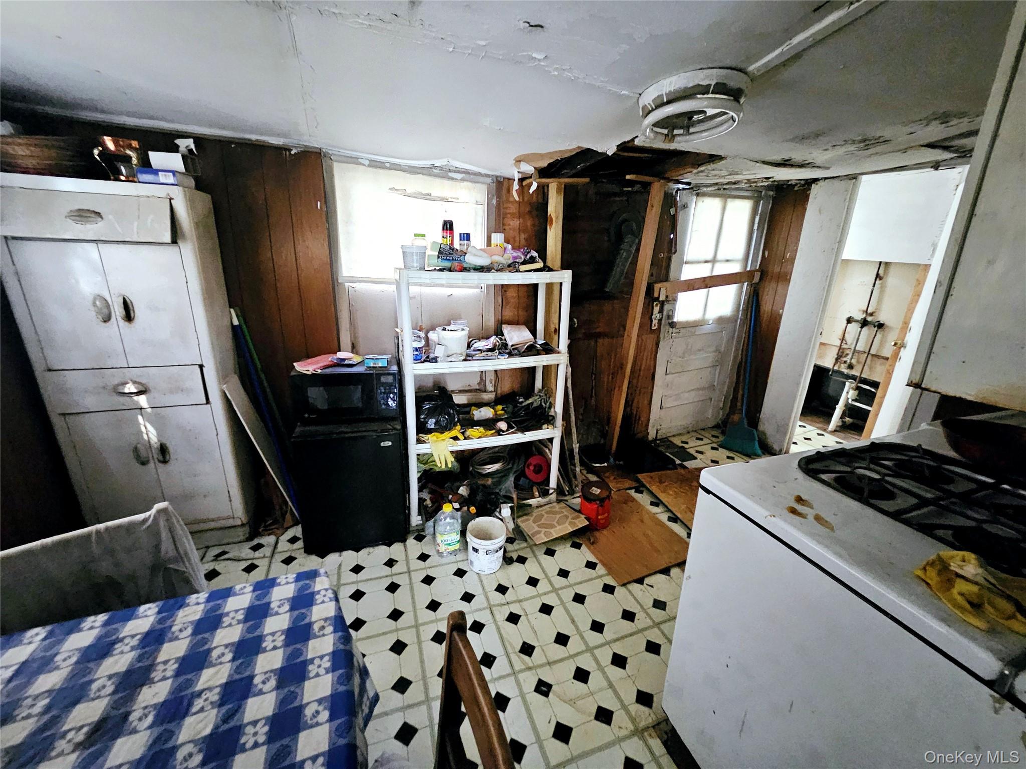549 Granny Road Medford, NY 11763 - Photo 29 of 37 a kitchen with a refrigerator and a stove