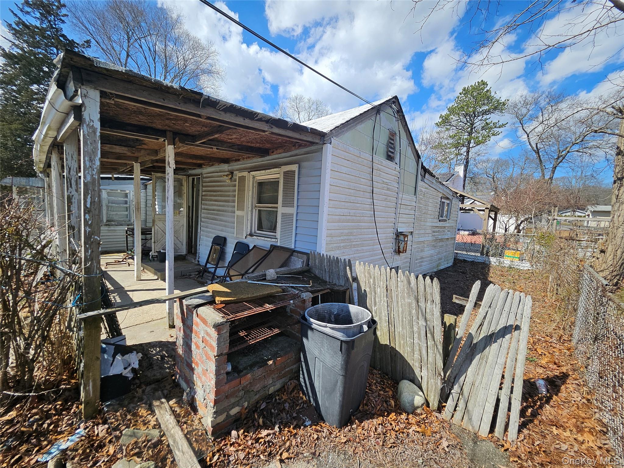 549 Granny Road Medford, NY 11763 - Photo 10 of 37 a view of a patio with table and chairs with wooden floor and fence