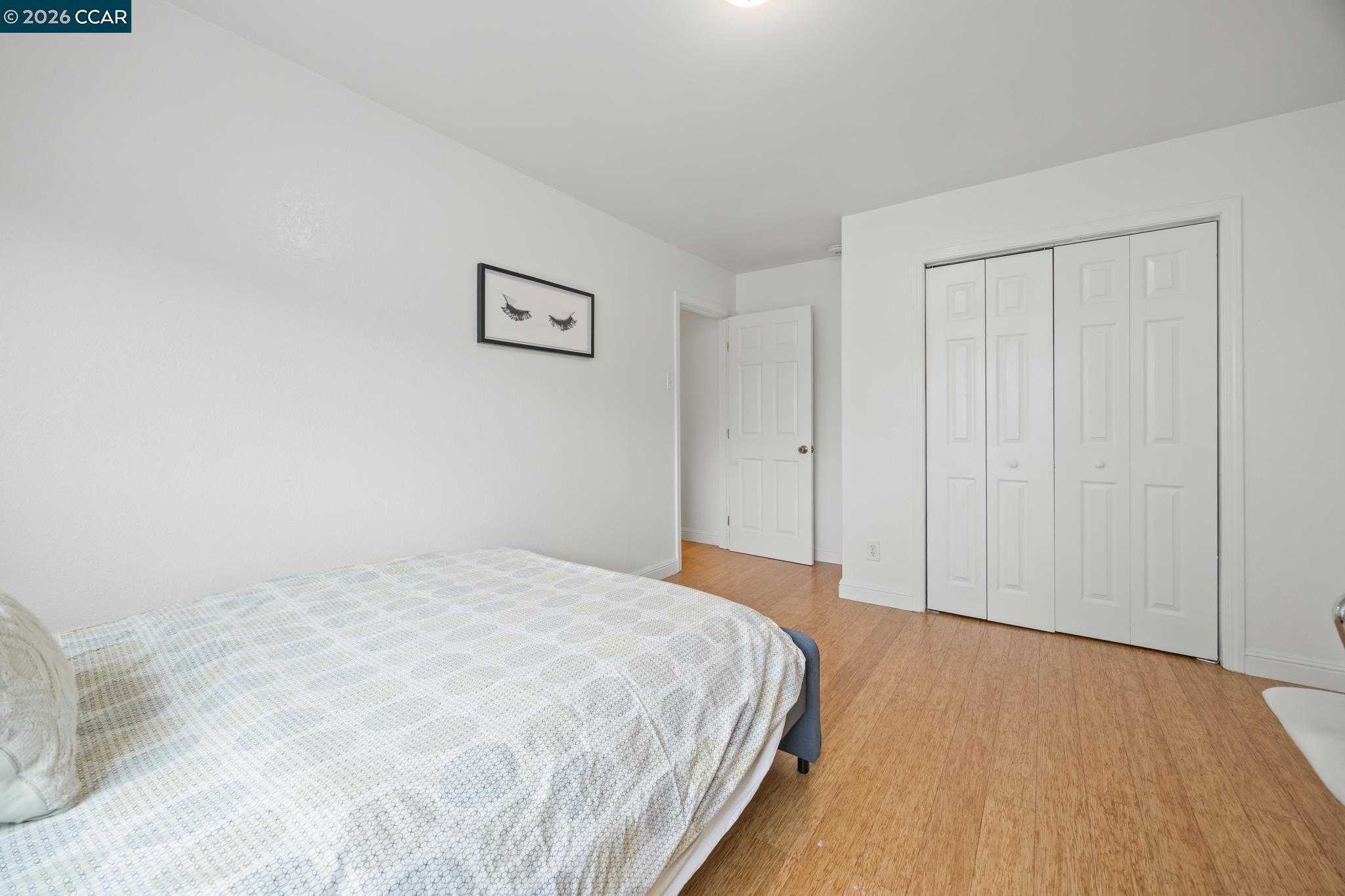 2327 Tenth Street, Unit 4 Berkeley, CA 94710 - Photo 16 of 39 a bedroom with a bed and a wall painting