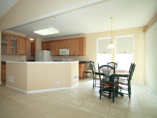 2949 Exeter Court West Dundee, IL 60118 - Photo 8 of 16 a living room with furniture a dining table and chairs