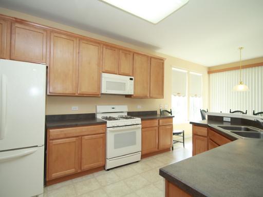 2949 Exeter Court West Dundee, IL 60118 - Photo 9 of 16 a kitchen with stainless steel appliances granite countertop a stove a sink a refrigerator and white cabinets