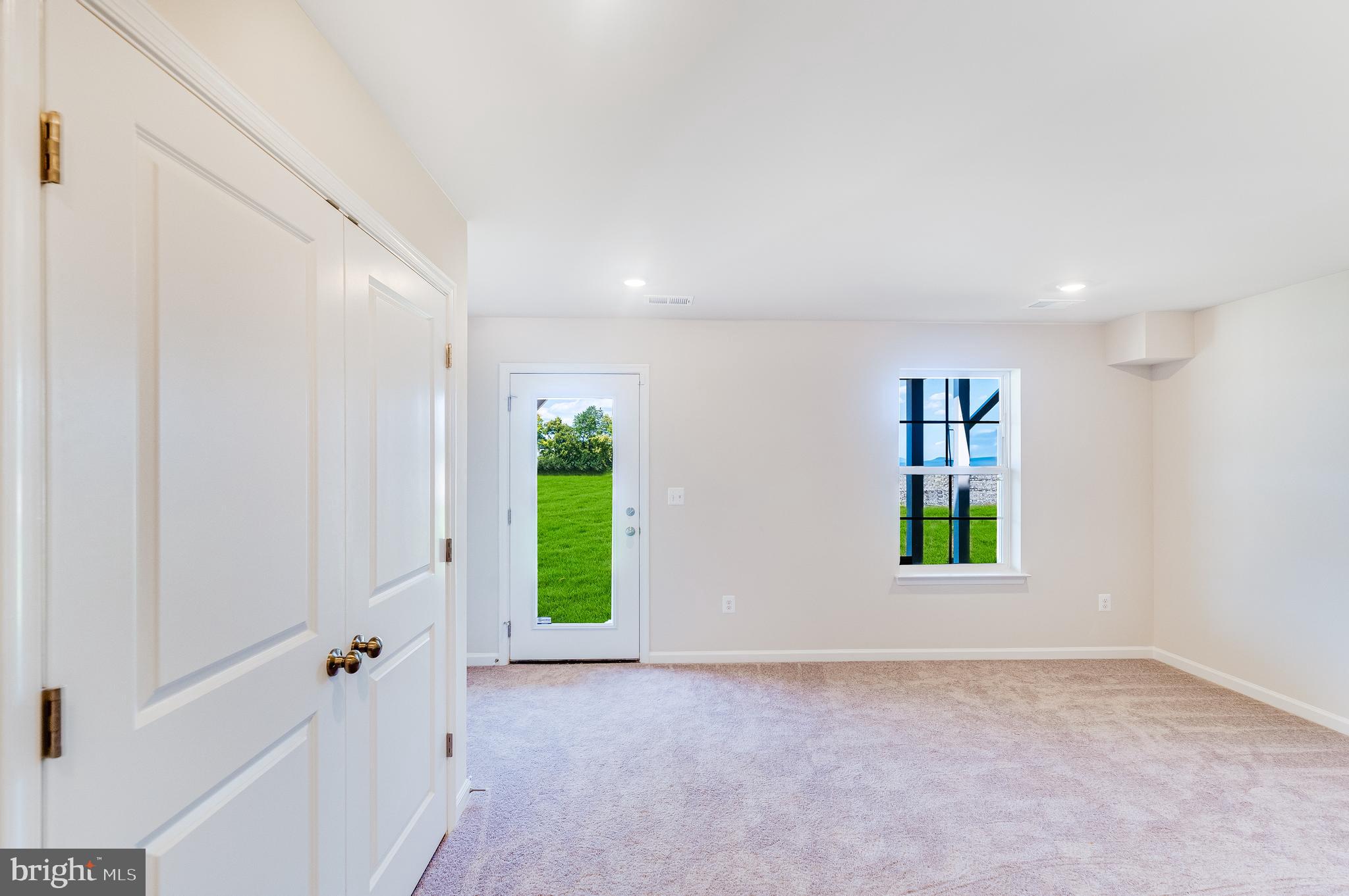 133 Gray Silver Road, Unit LANCASTER Inwood, WV 25428 - Photo 6 of 22 an empty room with windows and entrance