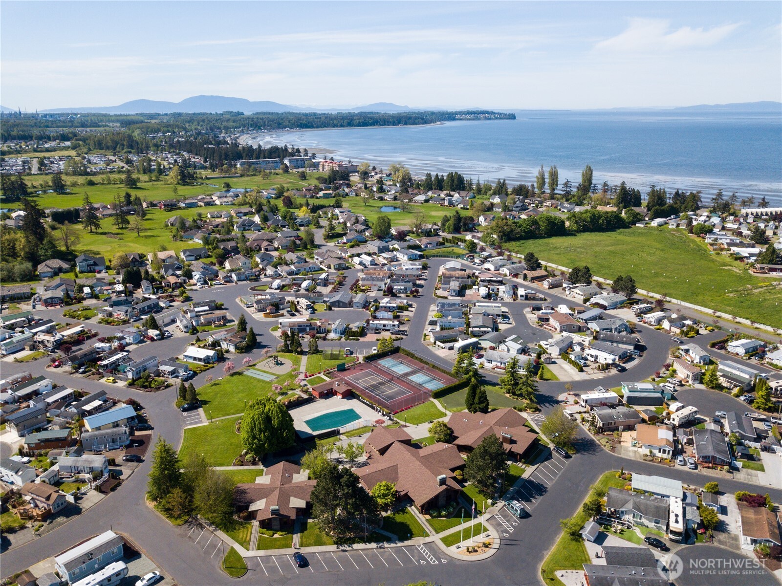 4751 Birch Bay Lynden Road, Unit 129 Blaine, WA 98230 - Photo 1 of 34 an aerial view of residential building and lake
