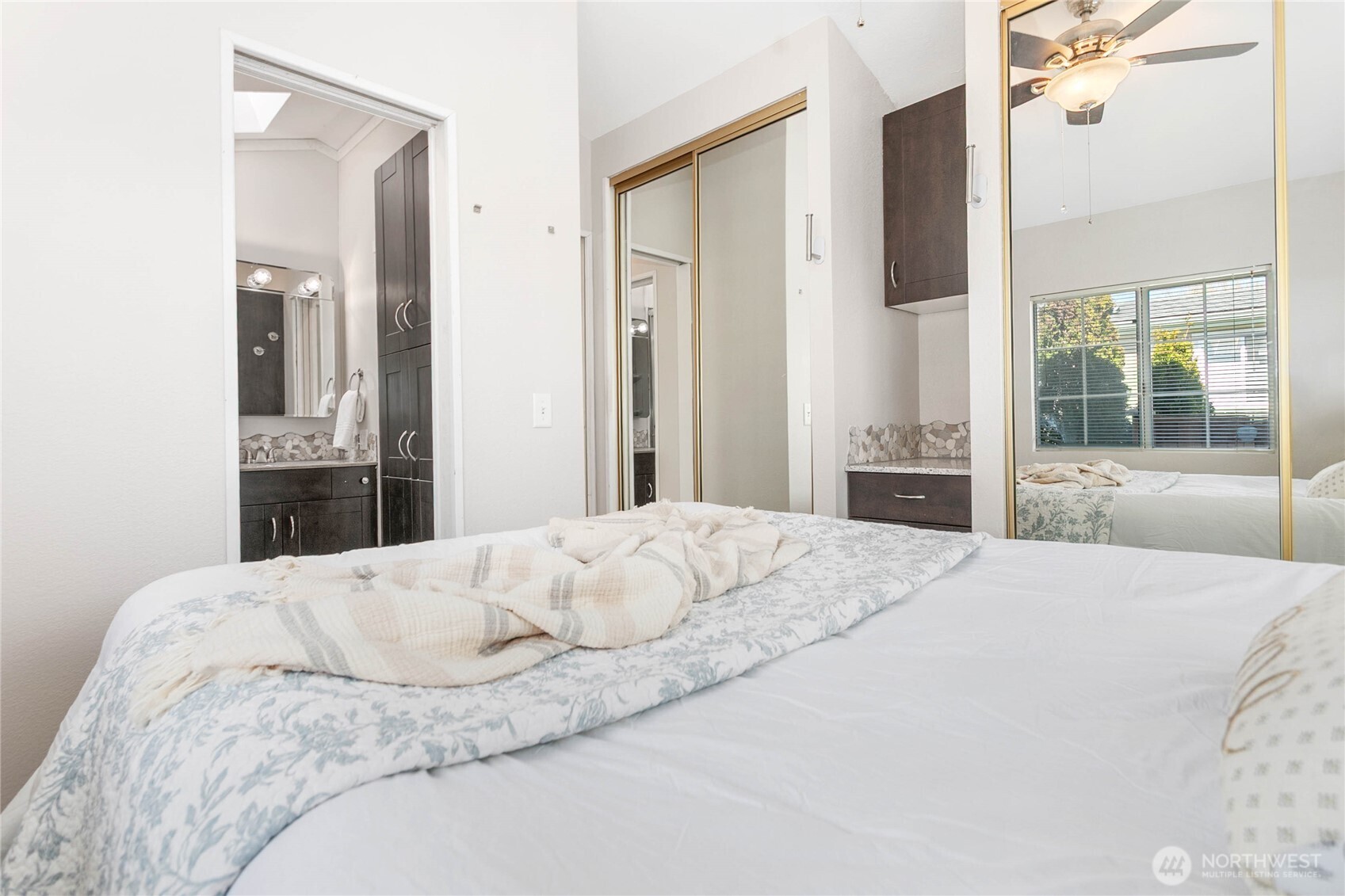 4751 Birch Bay Lynden Road, Unit 129 Blaine, WA 98230 - Photo 12 of 34 a bedroom with a bed and a large mirror