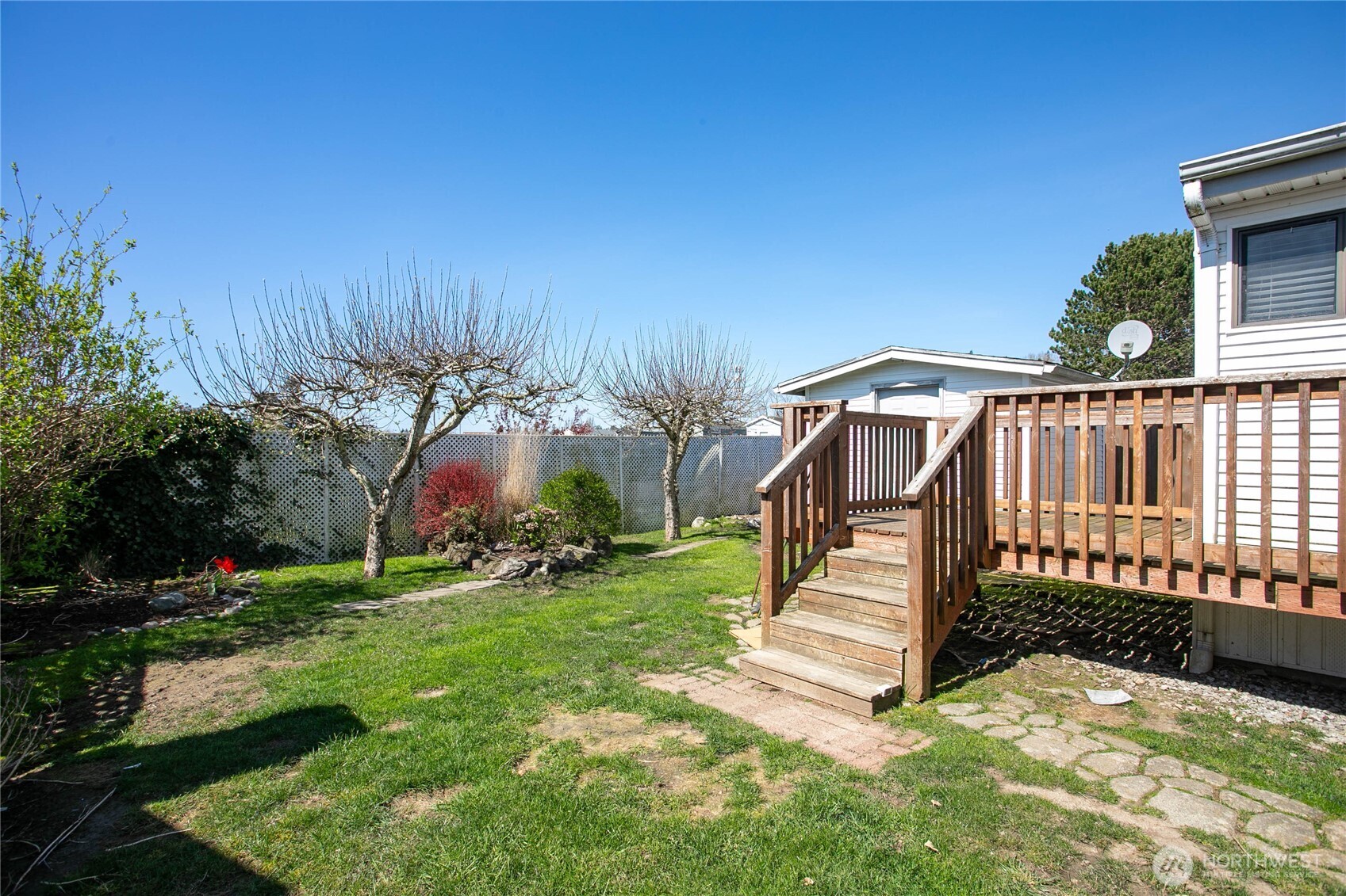 4751 Birch Bay Lynden Road, Unit 129 Blaine, WA 98230 - Photo 21 of 34 a view of a yard with a deck