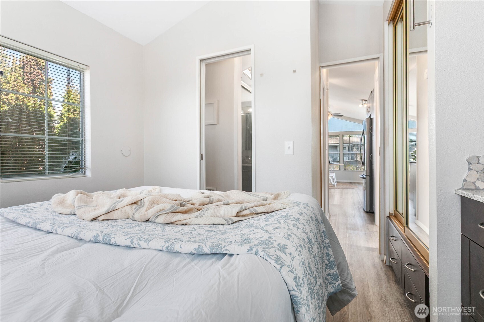 4751 Birch Bay Lynden Road, Unit 129 Blaine, WA 98230 - Photo 10 of 34 a bed sitting in a bedroom next to a window