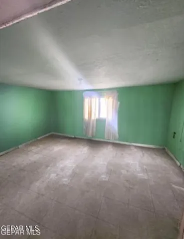 a view of an empty room with windows