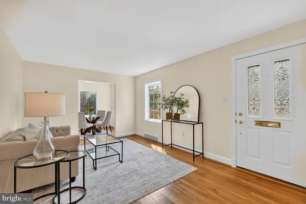 a living room with furniture a rug and a window