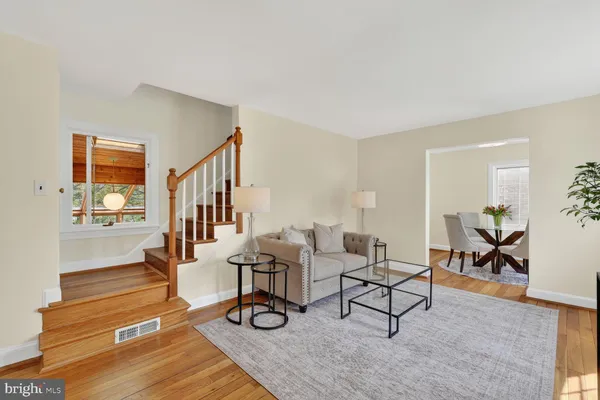 a living room with lots of furniture and paintings on the wall