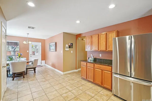 a kitchen with stainless steel appliances granite countertop a refrigerator and a sink