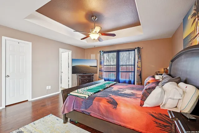 a bedroom with a bed and a chandelier