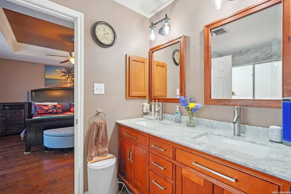 a bathroom with a granite countertop sink mirror vanity and toilet
