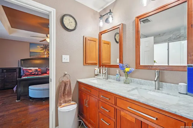 a bathroom with a granite countertop sink mirror vanity and toilet