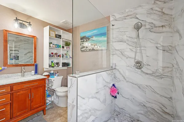 a bathroom with a sink toilet and shower