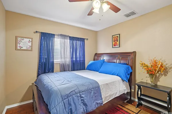 a bedroom with a large bed and a chandelier