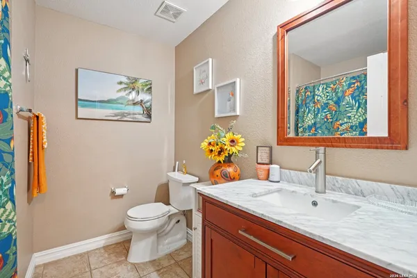 a bathroom with a toilet sink and mirror
