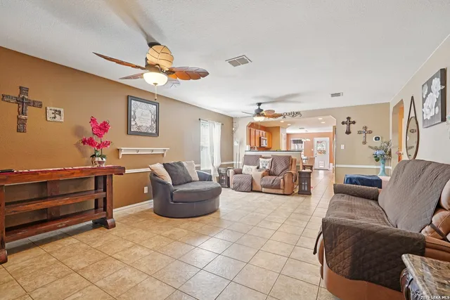 a living room with furniture a rug and white walls