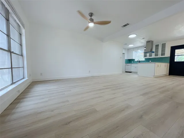 a view of kitchen with wooden floor and window