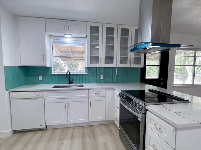 a kitchen with a sink and a stove top oven