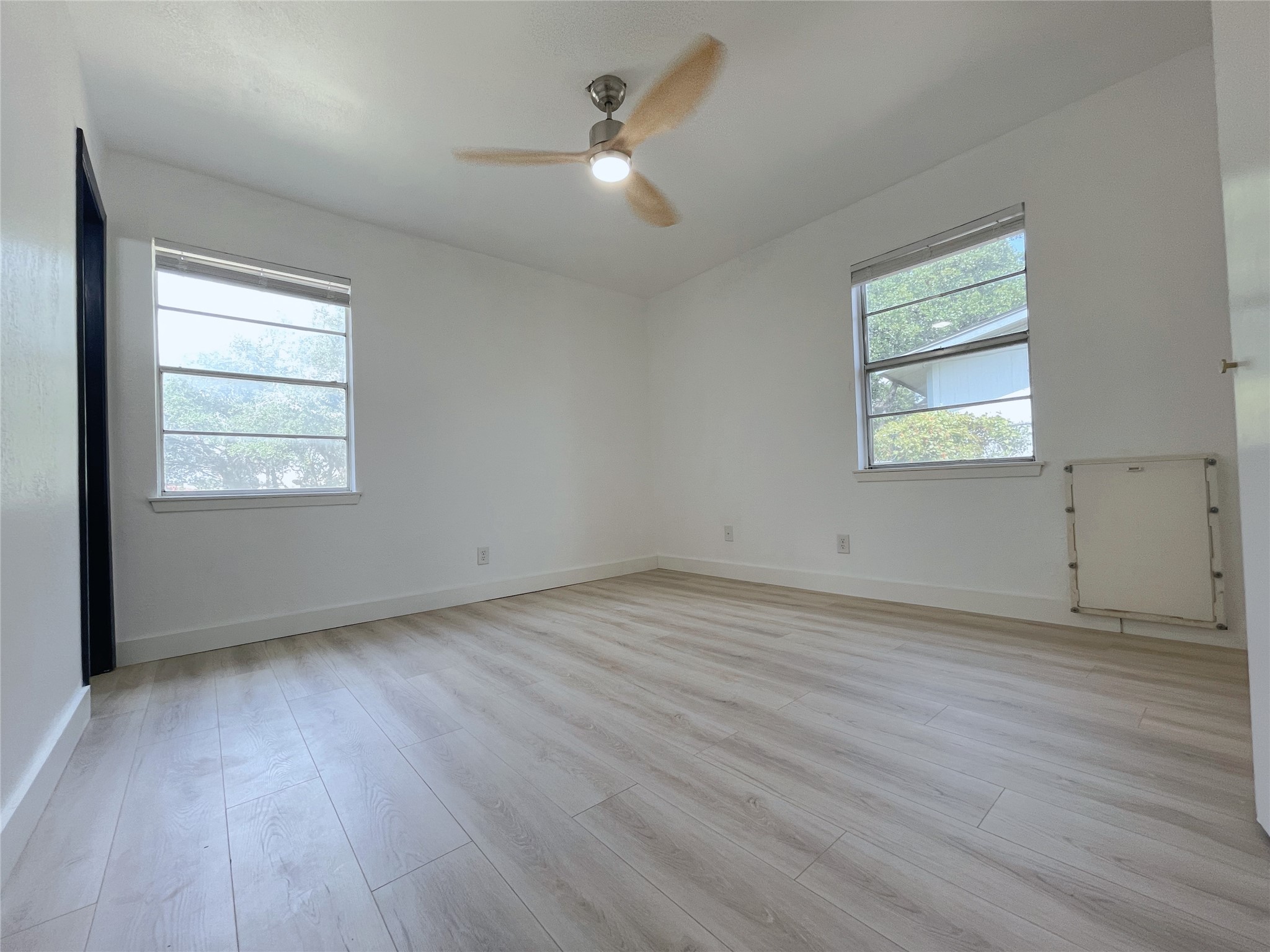 1005 Doris Lane Cedar Park, TX 78613 - Photo 7 of 19 an empty room with wooden floor and windows