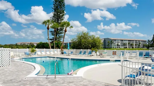 an aerial view of a house with swimming pool and outdoor seating
