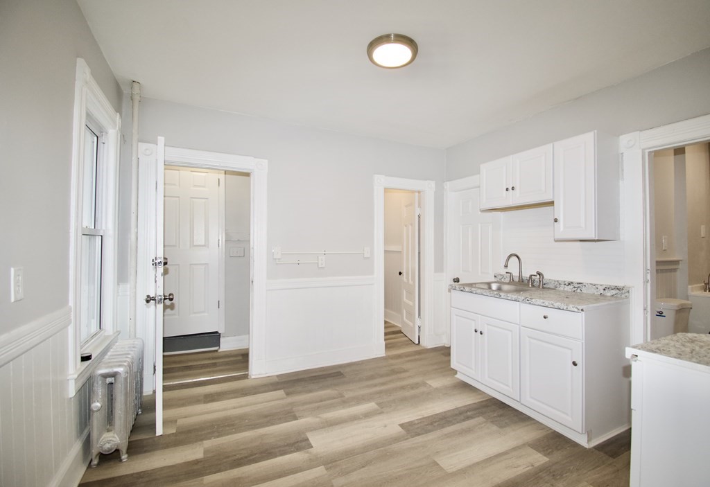 72 Malden Street Springfield, MA 01108 - Photo 11 of 25 a view of a kitchen with white cabinets