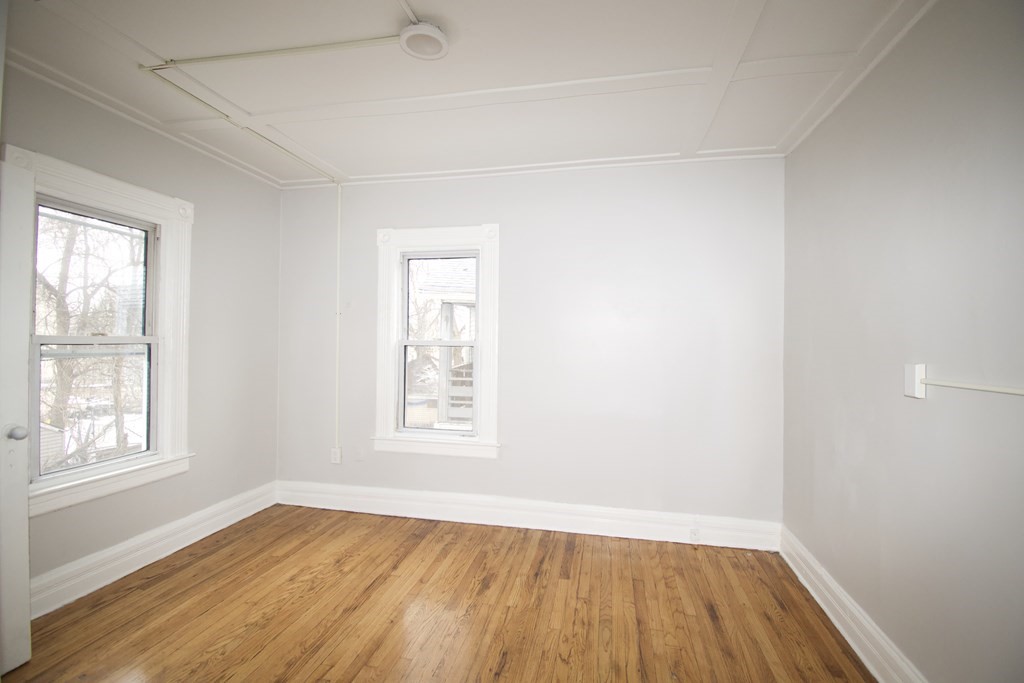 72 Malden Street Springfield, MA 01108 - Photo 18 of 25 an empty room with wooden floor and windows