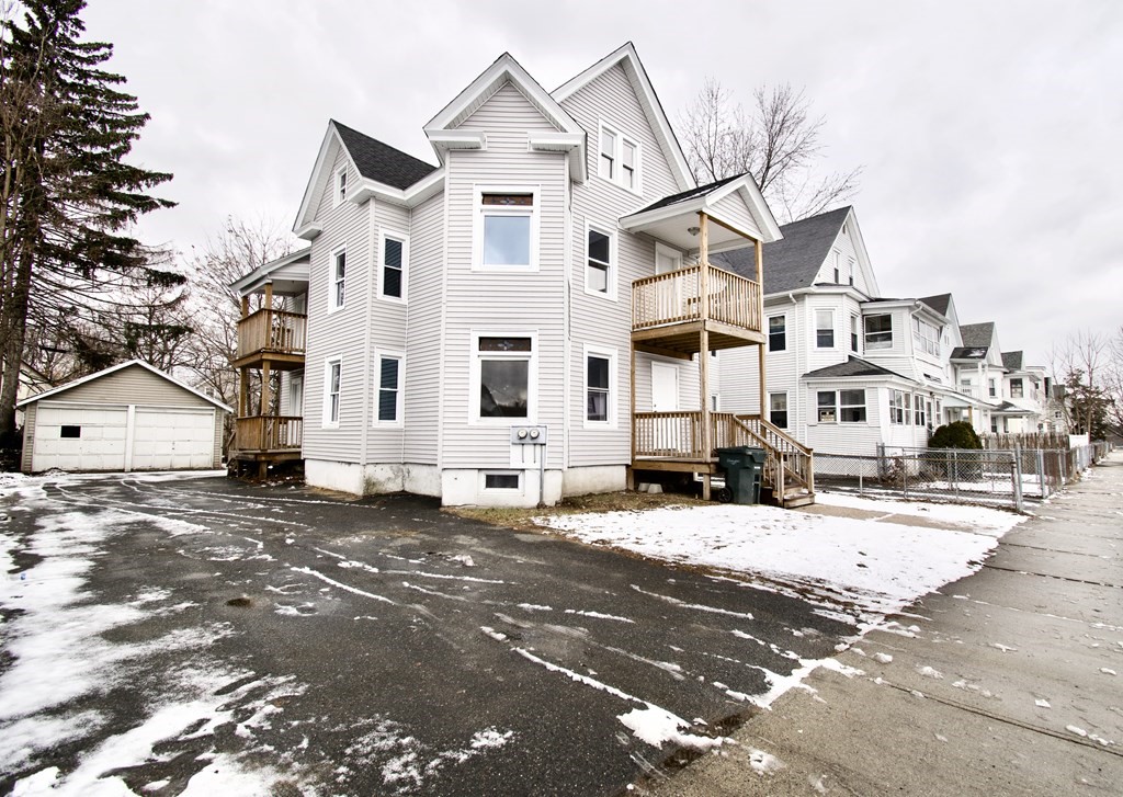 72 Malden Street Springfield, MA 01108 - Photo 2 of 25 a view of a white house with a street
