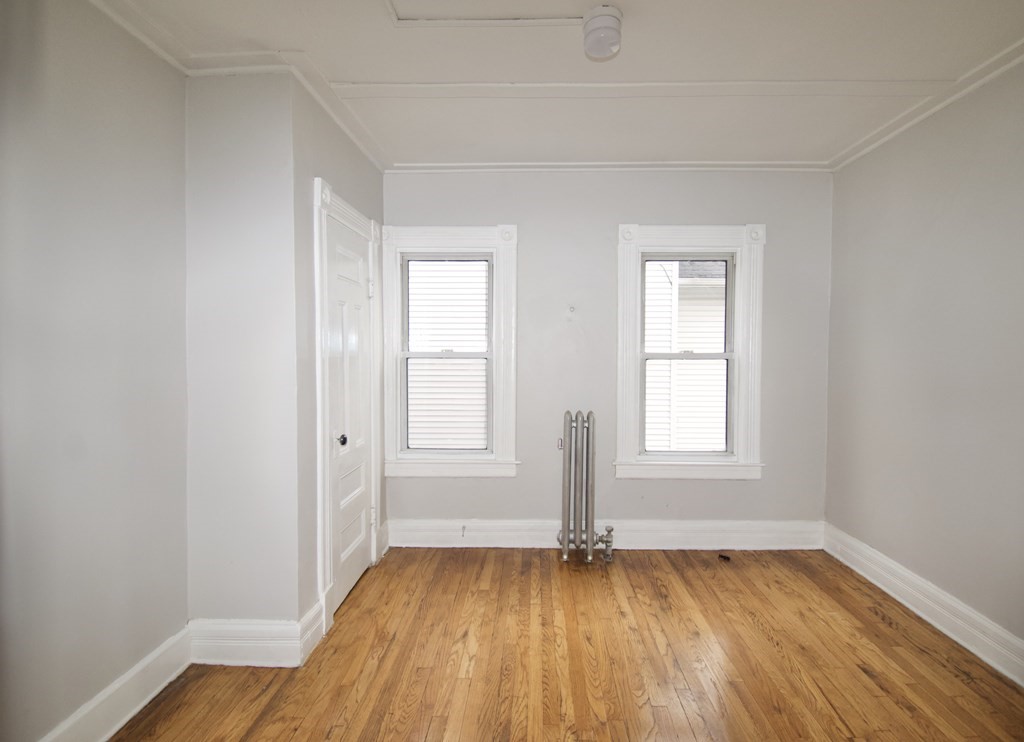 72 Malden Street Springfield, MA 01108 - Photo 21 of 25 an empty room with wooden floor and windows