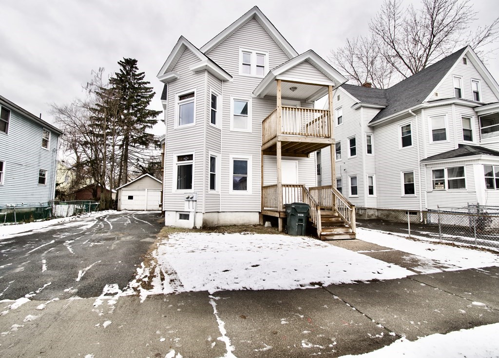 72 Malden Street Springfield, MA 01108 - Photo 3 of 25 a view of a white building among the street with palm trees