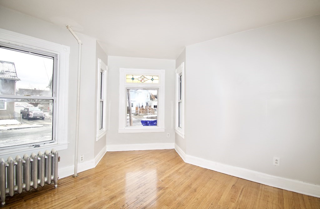 72 Malden Street Springfield, MA 01108 - Photo 7 of 25 a view of a hallway with wooden floor and a window