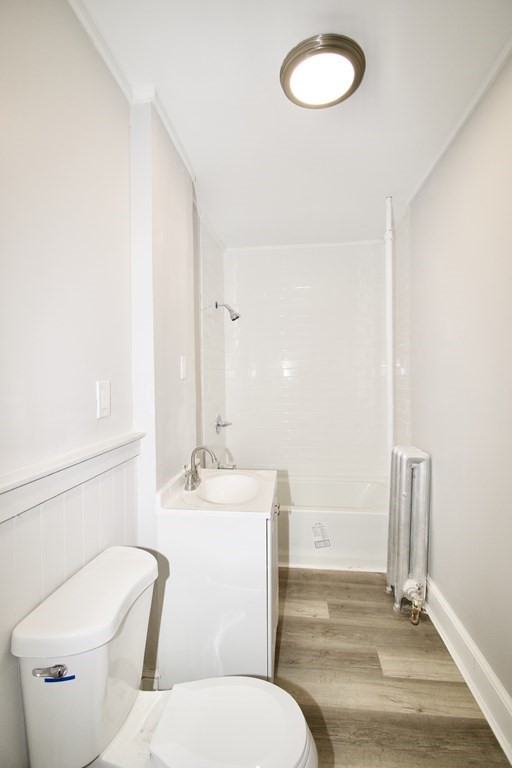 72 Malden Street Springfield, MA 01108 - Photo 10 of 25 a bathroom with a toilet sink and mirror