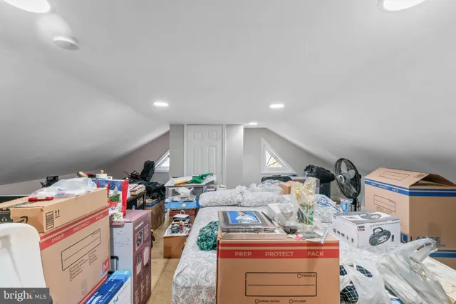 a living room with lots of furniture and clutter