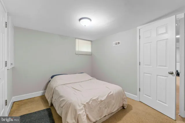 a bedroom with a bed and a rug