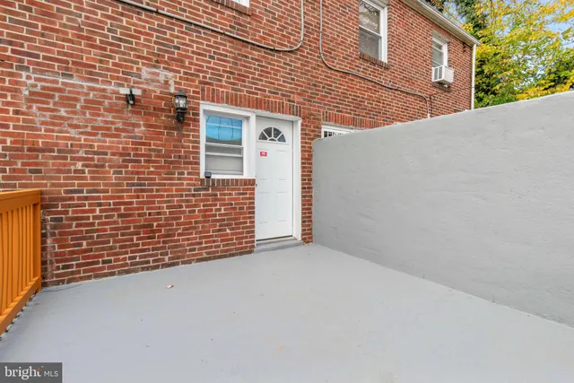 a view of a brick house with an empty space